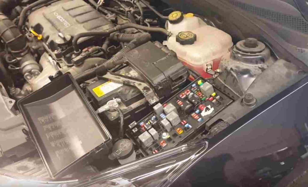 general photo of the location of the fuse box under the hood